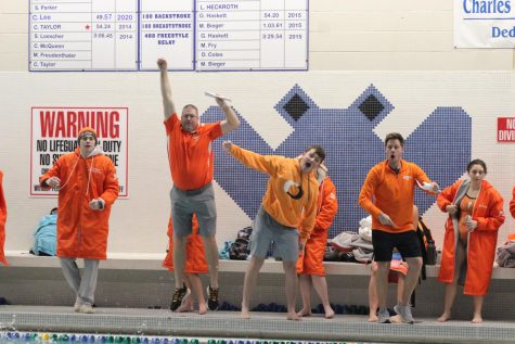 Coaches cheer for the East swimmers.