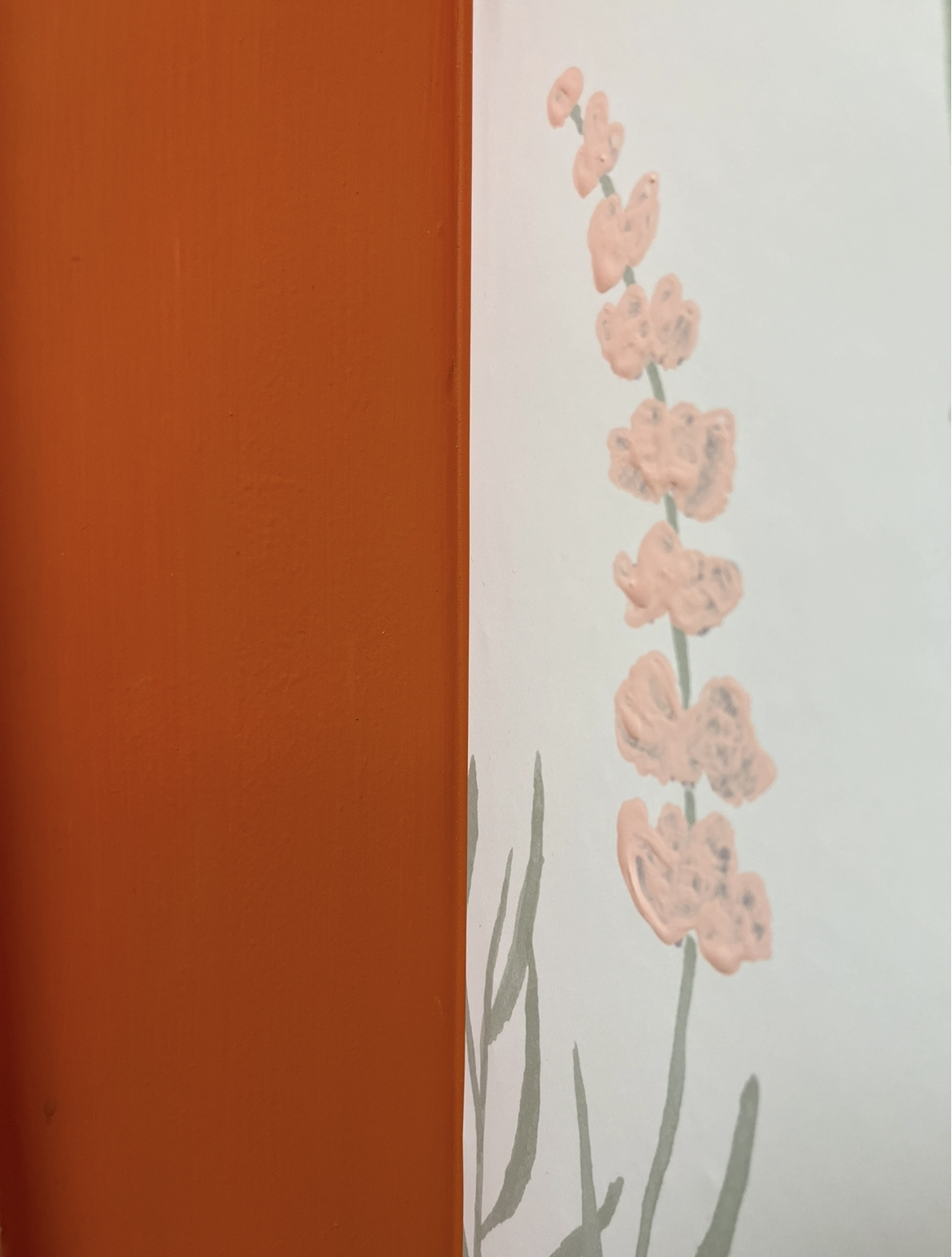 Side by side view of the original paint and new wallpaper.
